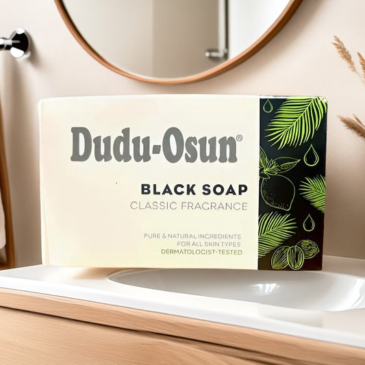 Dudu Osun African Black Soap box with classic fragrance label, placed on a bathroom sink. Ideal for all skin types and dermatologist-tested.