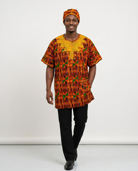 Man wearing a patterned orange and yellow shirt with black pants on a white background