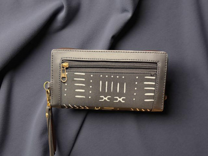 Black wallet with geometric patterns on a dark fabric background