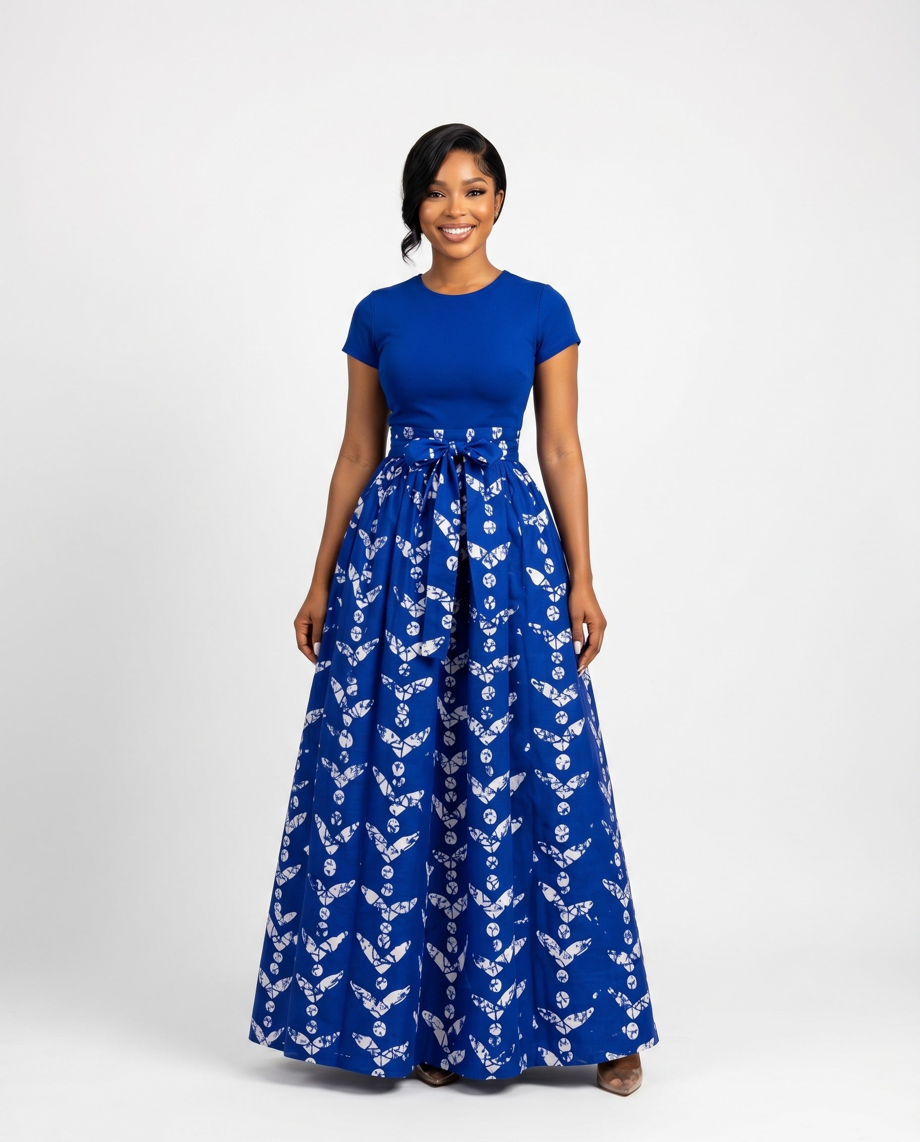 Woman wearing a blue skirt with a white floral pattern on a white background