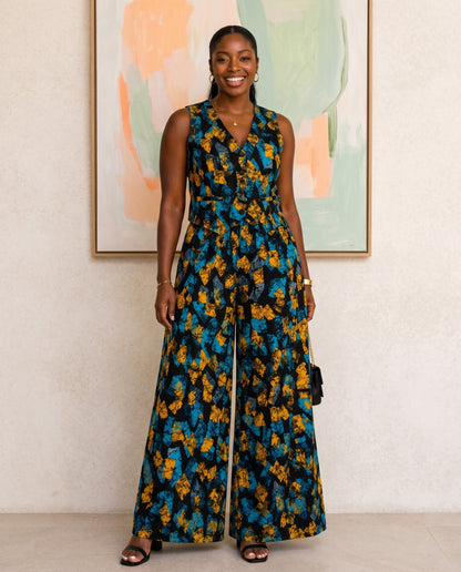 Woman in a floral jumpsuit standing in front of abstract art