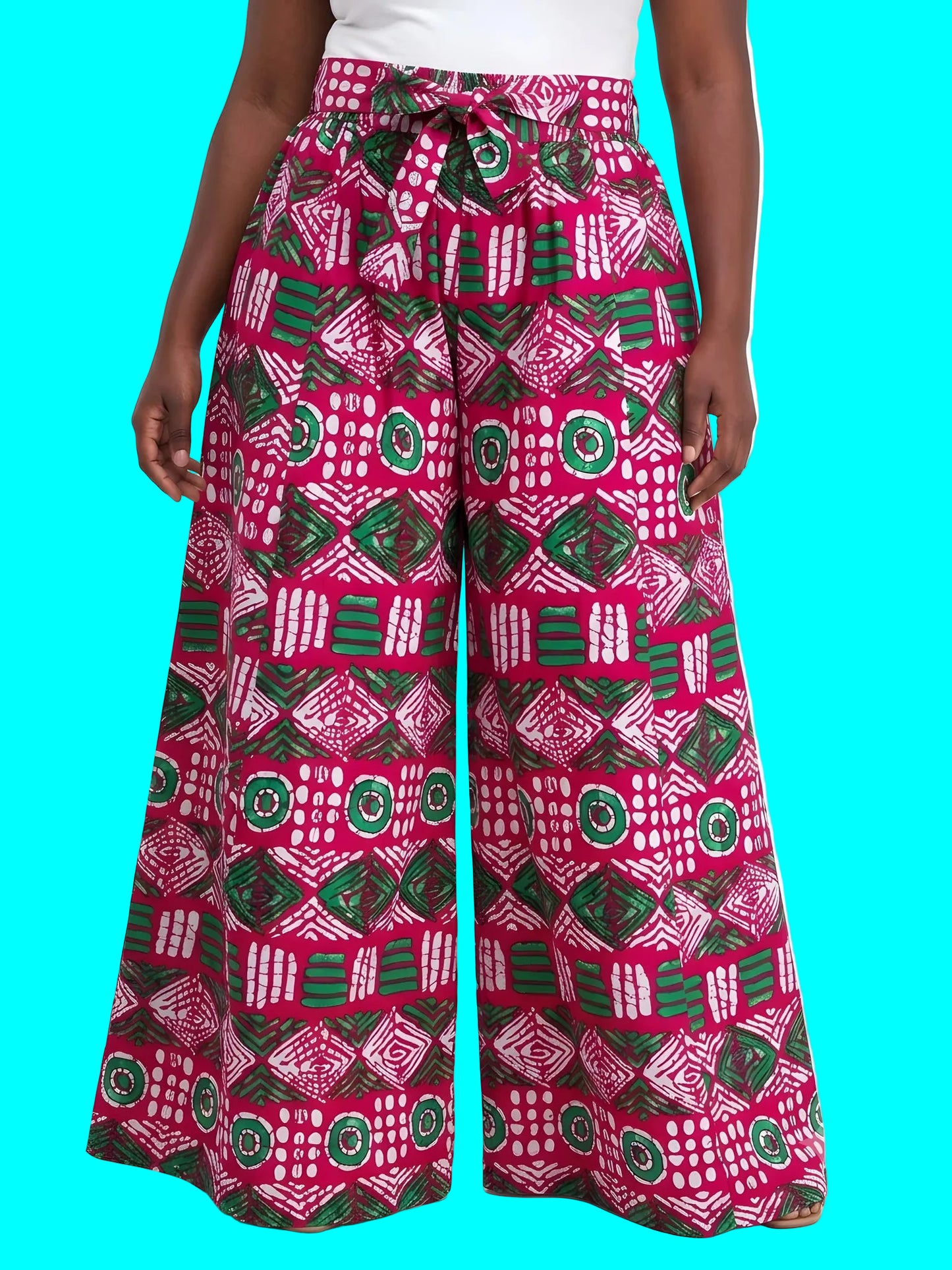 Person wearing pink and green patterned wide-leg pants on a white background