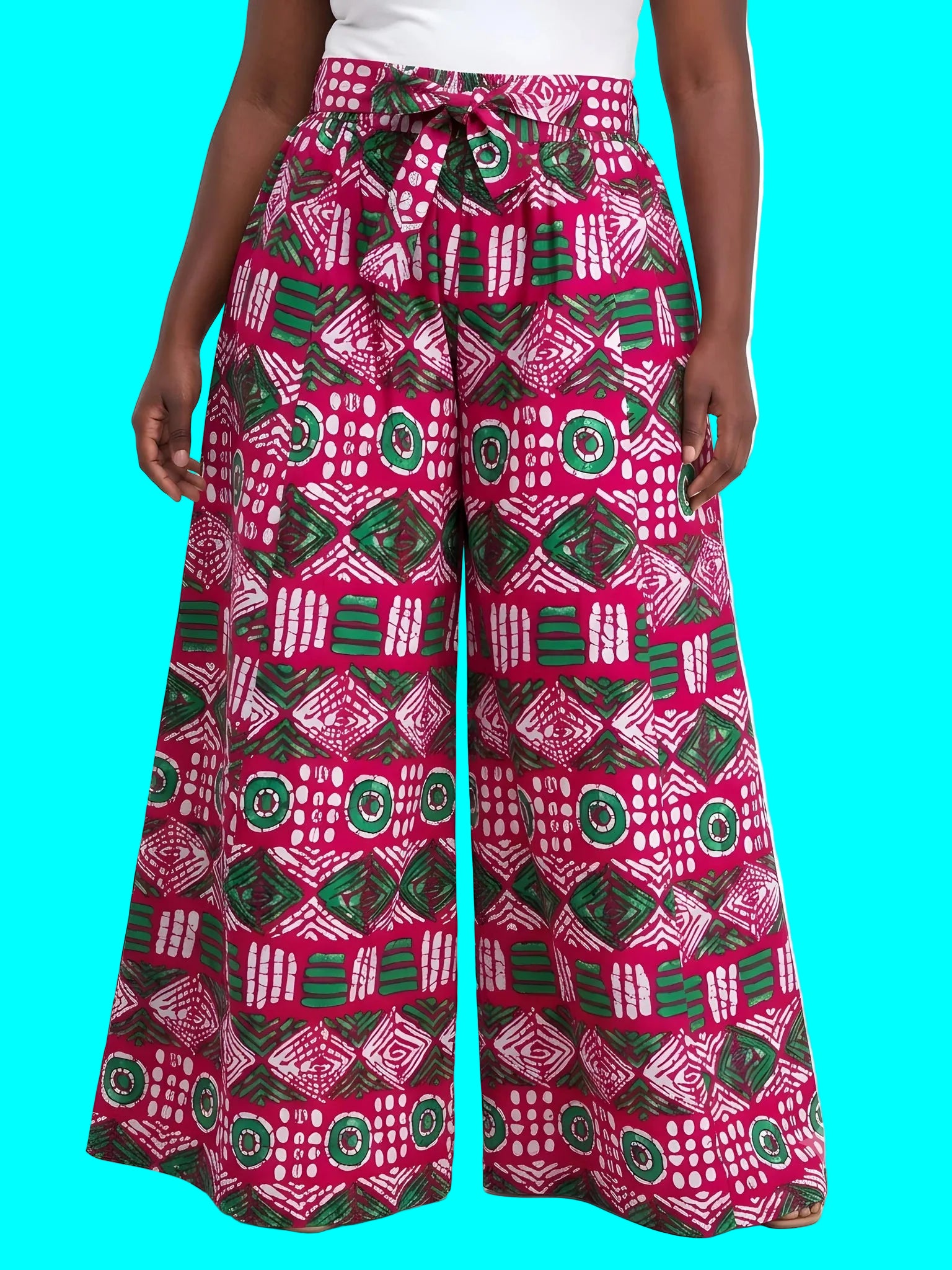 Person wearing pink and green patterned wide-leg pants on a white background