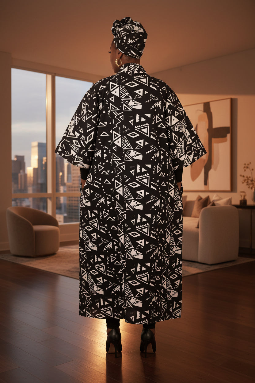 Person wearing a black and white patterned outfit on a white background