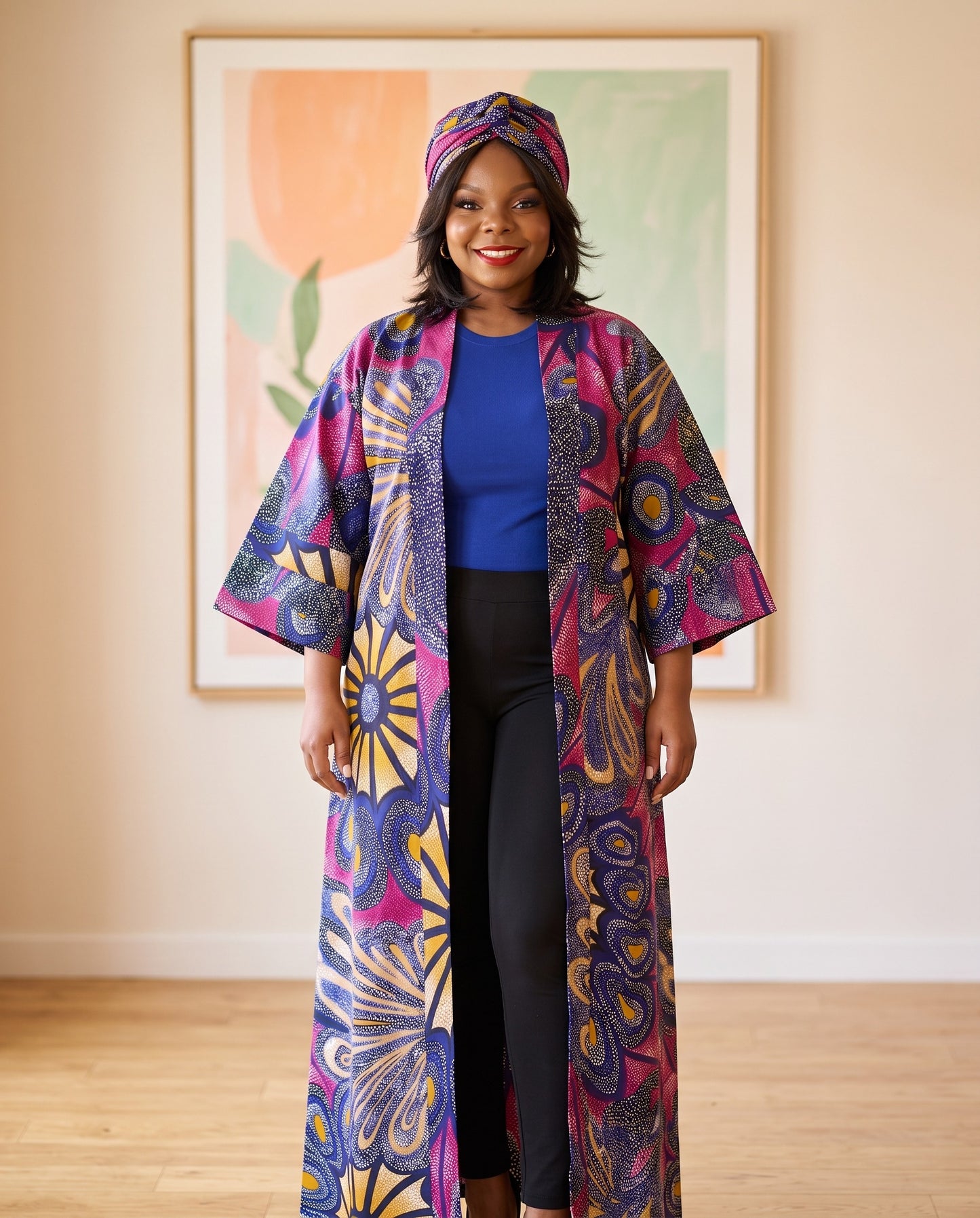 Woman wearing a colorful patterned kimono standing in a room with a painting on the wall.