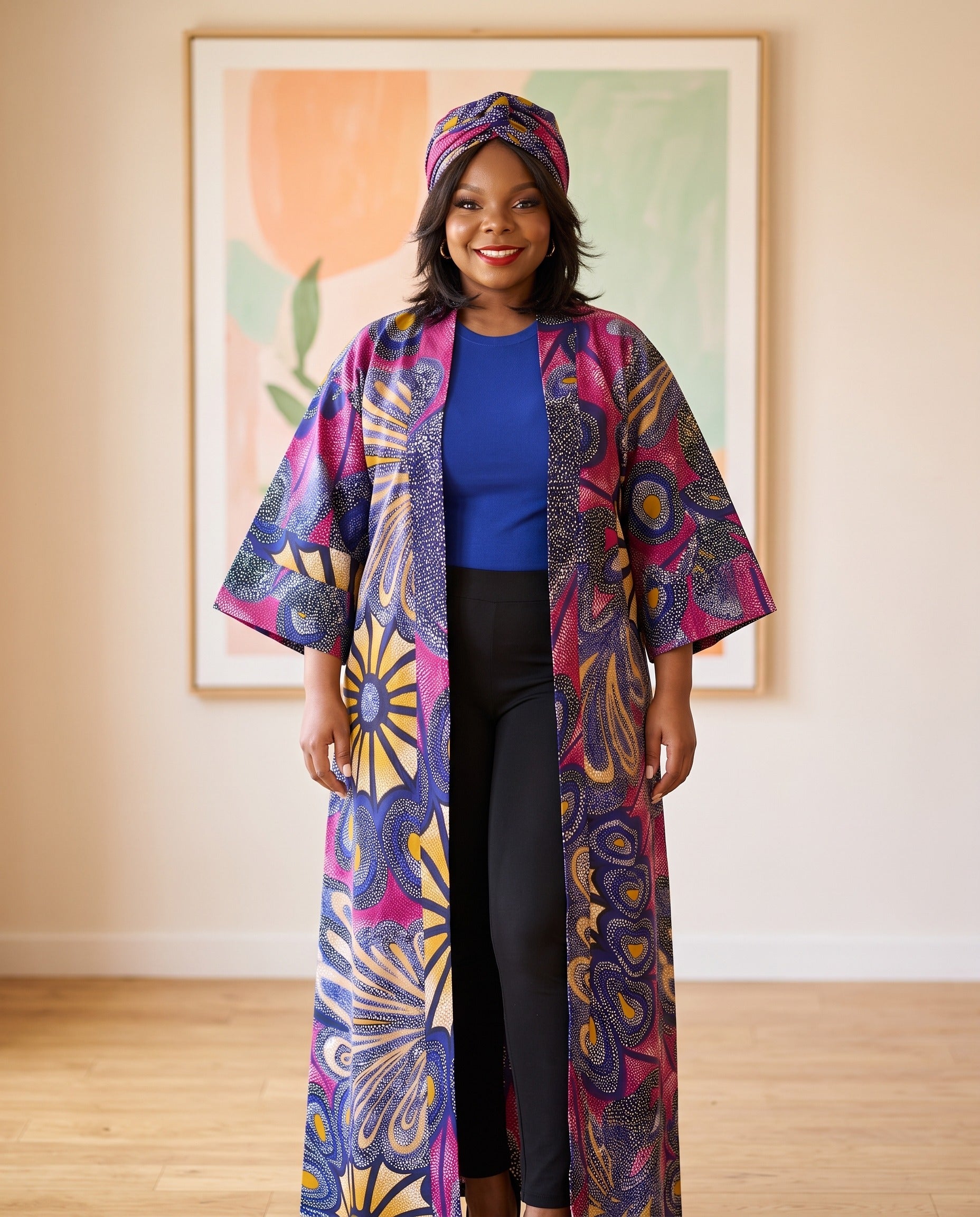 Woman wearing a colorful patterned kimono standing in a room with a painting on the wall.