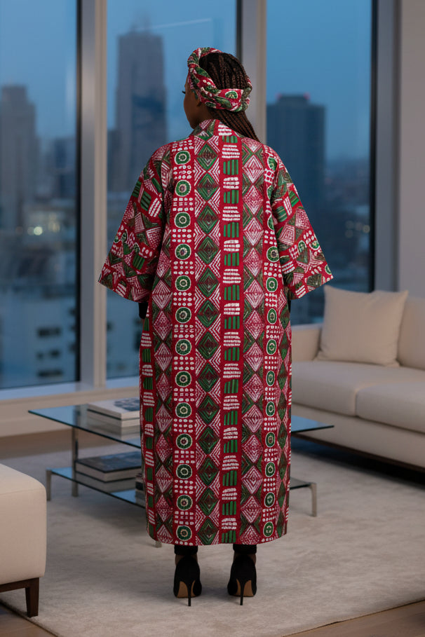 Woman wearing a red and green patterned dress on a white background