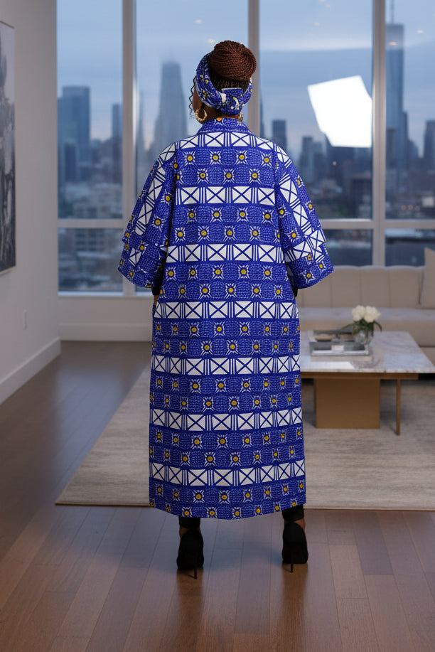 Woman wearing a long blue patterned dress on a white background