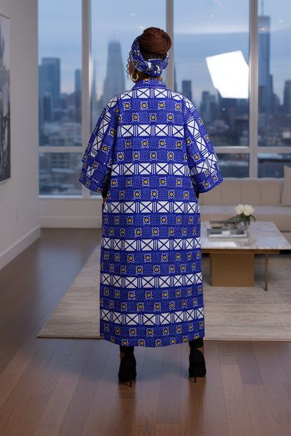 Woman wearing a long blue patterned dress on a white background