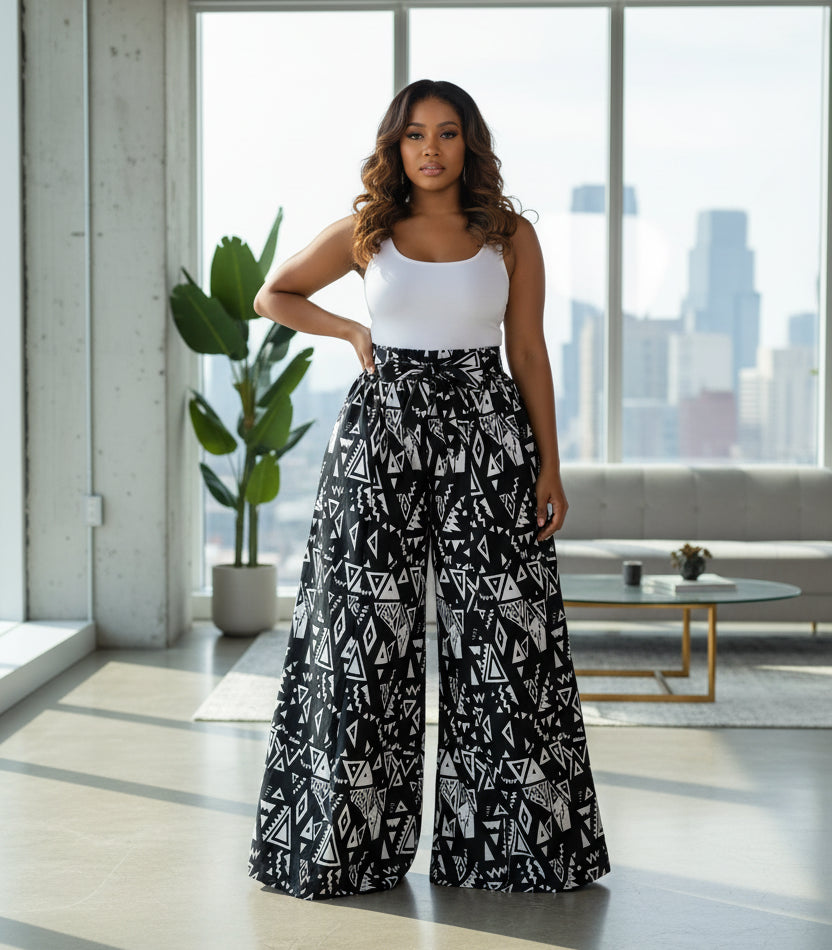 Black and white patterned wide-leg pants worn by a person on a white background