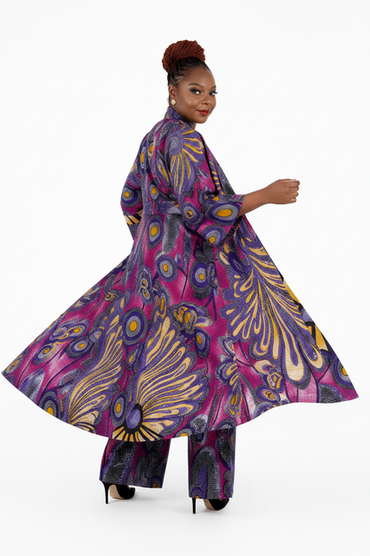 Woman wearing a vibrant, patterned outfit on a white background